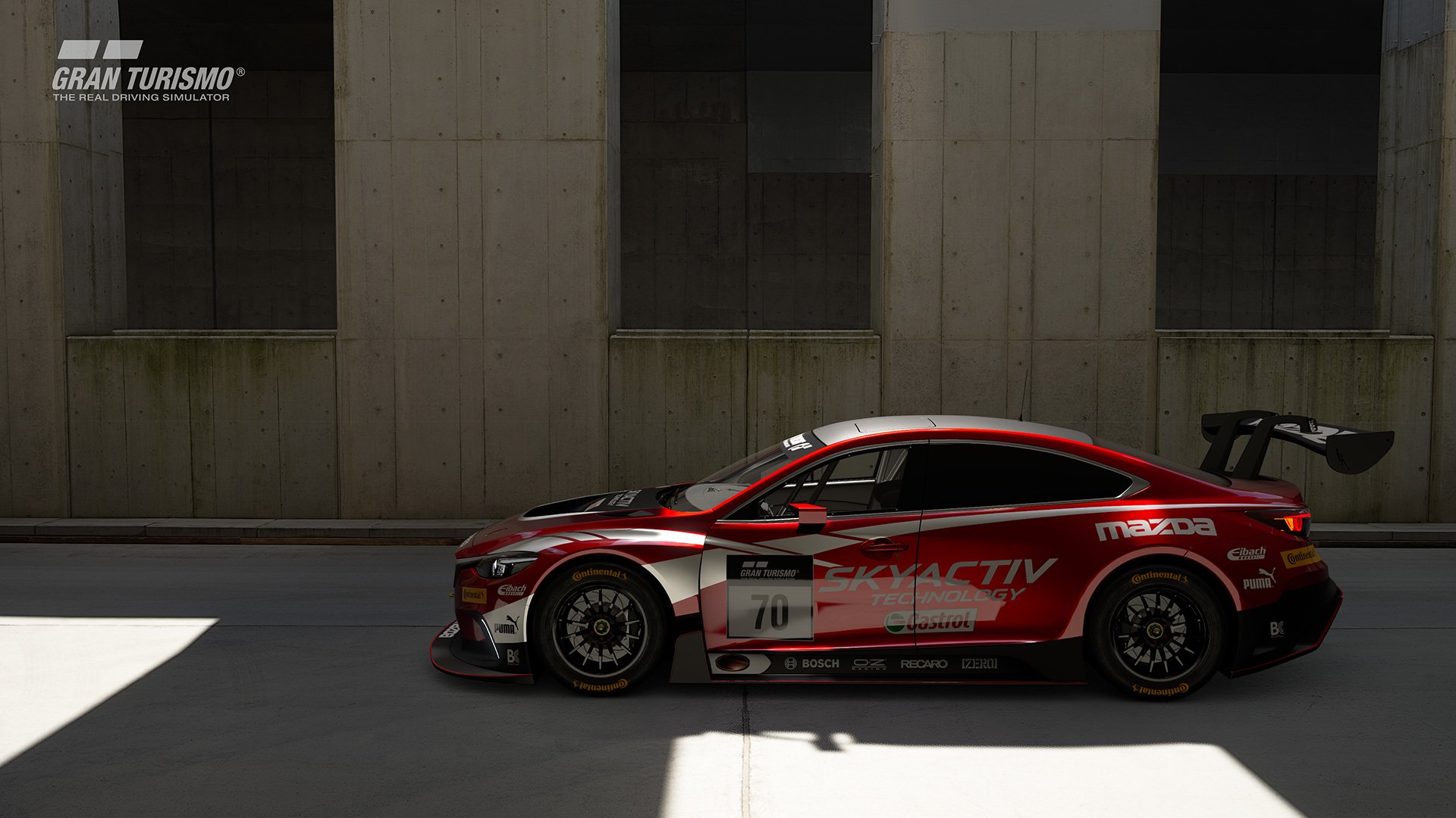 Gran Turismo Sport Mazda GT4 in front of wall